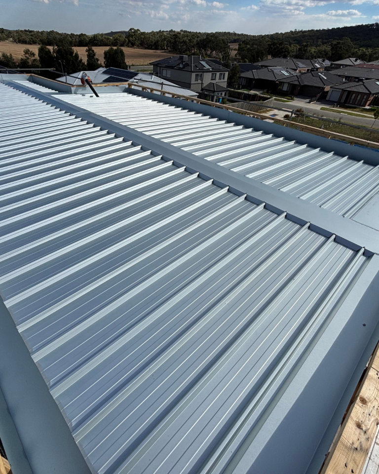 Close-up view of a Klip-Lok metal roofing installation on a residential project completed by Pitch Perfect Roof Plumbing.