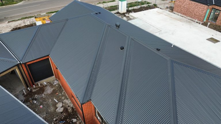 Close-up view of a newly installed dark metal roof on a brick residential home by Pitch Perfect Roof Plumbing in Melbourne.