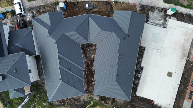 Aerial view of a multi-residential development featuring complex dark metal roofing installed by Pitch Perfect Roof Plumbing in Melbourne.