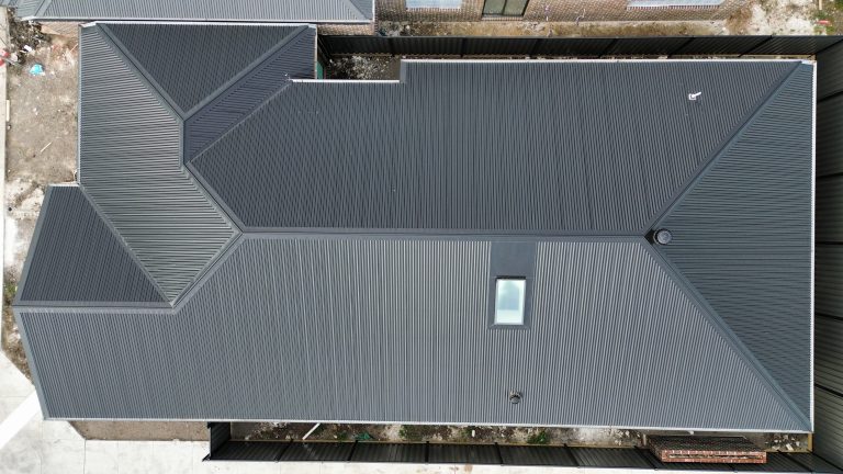 Overhead view of a newly installed dark Klip-Lok metal roof on a residential home completed by Pitch Perfect Roof Plumbing in Melbourne.