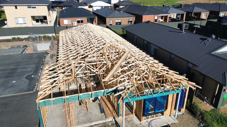 Aerial view of a residential timber roof frame under construction before metal roofing installation by Pitch Perfect Roof Plumbing.