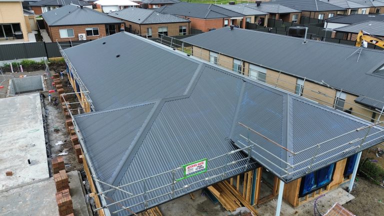 Wide view of metal roofing installed across a multi-residential development by Pitch Perfect Roof Plumbing.